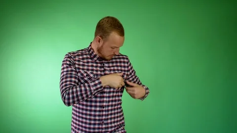 A bearded guy. A plaid shirt. Asks to wait. And takes a thumb up from the breast Video stock 115770092