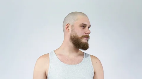 Bearded guy shows his bald head in profile and full face Stock Footage 121975437