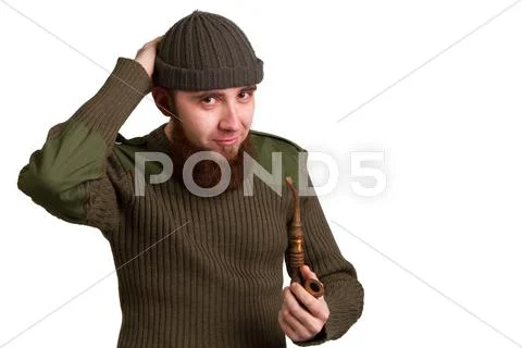 Bearded guy smoking a pipe on a light background Stock Photos