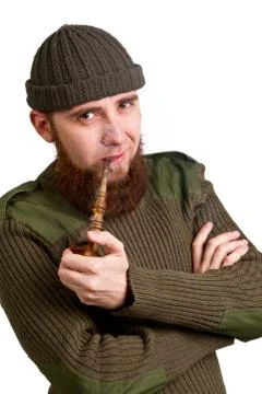 Bearded guy smoking a pipe Stock Photos