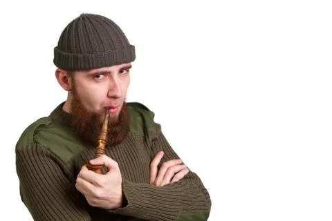 Bearded guy smoking a pipe Stock Photos
