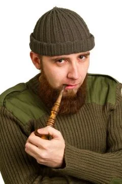 Bearded guy smoking a pipe Stock Photos