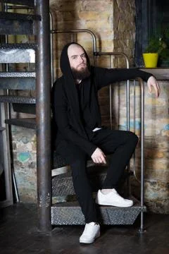 A bearded guy on the stairs. Stock Photos