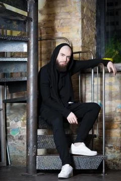 A bearded guy on the stairs. Stock Photos