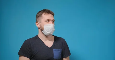 Bearded guy takes off white disposable mask shakes with joy Stockbeeldmateriaal 128096077