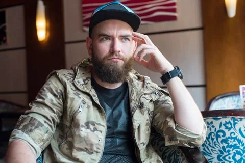 A bearded guy. Thoughtful bearded guy indoors. Foto stock