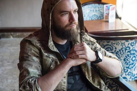 A bearded guy. Thoughtful bearded guy indoors. Stock Photos
