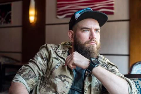 A bearded guy. Thoughtful bearded guy indoors. Stock Photos
