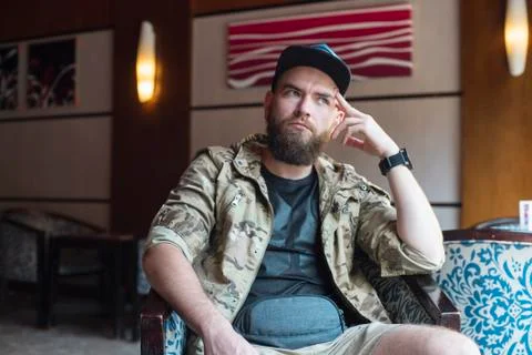 A bearded guy. Thoughtful bearded guy indoors. Stock Photos