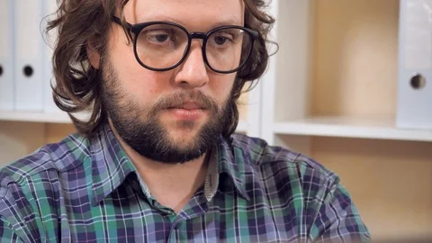 Bearded guy use pc in office Stock Footage 89105803