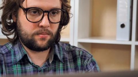 Bearded guy use pc in office Stock Photos