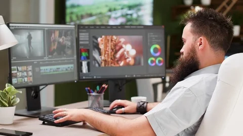 Bearded guy work as video editor or colorist in creative media agency Video stock 110466455