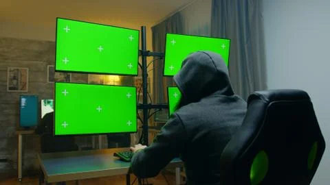 Bearded hacker hiding his face wearing a hoodie. 스톡 사진
