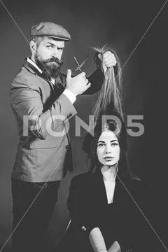 Bearded Hairdresser making hair styling and cut. Hairdressers work. Barber shop Stock Photos