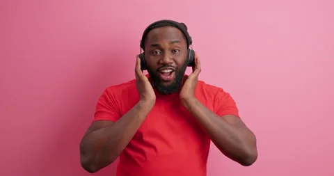Bearded handsome black man enjoys listening lyrics song sings favorite melody Stock Footage 150298847