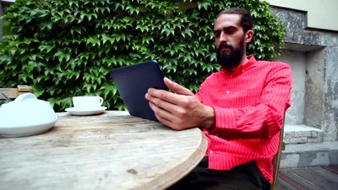 Bearded handsome business man using tablet device resting in cafe outdoor 스톡 동영상 133595037