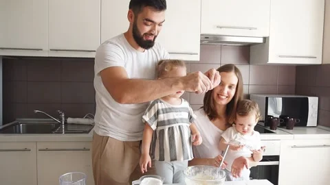 Bearded handsome happy daddy breaking the egg into the bowl Stock Footage 118895744