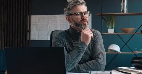 Bearded Handsome man Architect thinking about work while sitting in Office. Видео 126243453