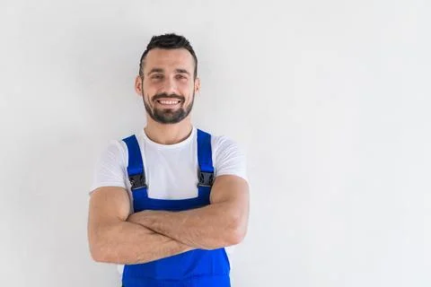 Bearded handyman in overalls posing on camera Stock Photos
