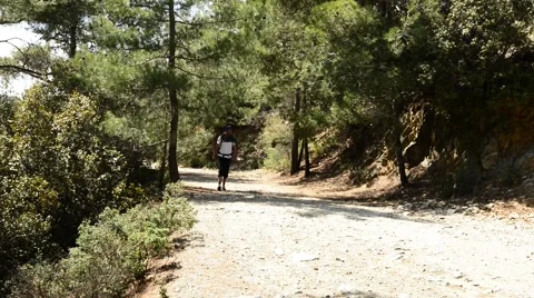 Bearded hiker with a backpack goes on a mountain trail Stock-Footage 63399633