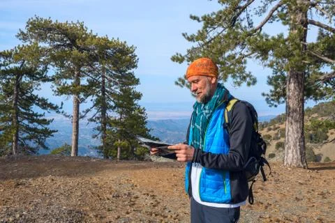 Bearded hiker looking at map Stock Photos