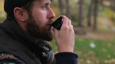Bearded hipster drinks tea from a bowl outdoors. Chinese tea ceremony Stock Footage 229860898