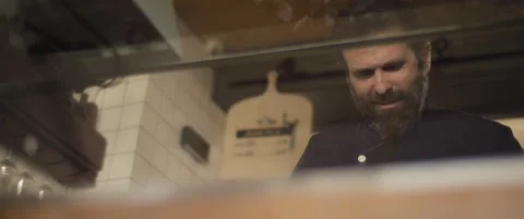 A bearded hispanic chef working in the restaurant kitchen. Slow motion, mediu Stock Footage 147517603