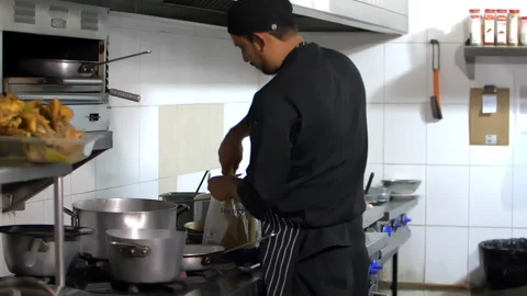 Bearded Hispanic chefs cooking in a restaurant kitchen Stock Footage 149212933