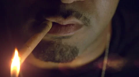 Bearded Hispanic lights cigar and blows out smoke in slow motion close up Stock Footage 44555212