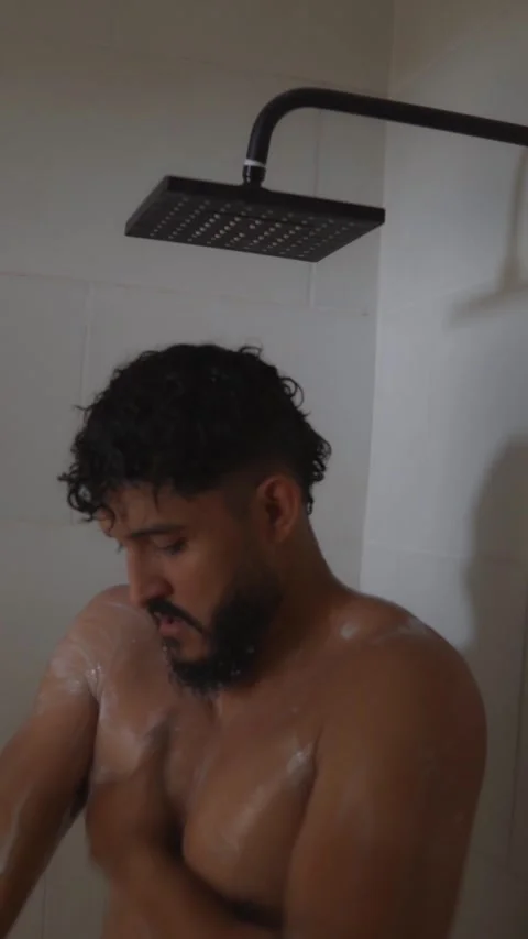 Bearded hispanic male taking shower and washing body Stock Footage 336975242