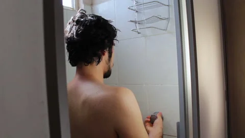 Bearded Hispanic young man taking a relaxing bath in the bathroom shower Stock-Footage 132533039