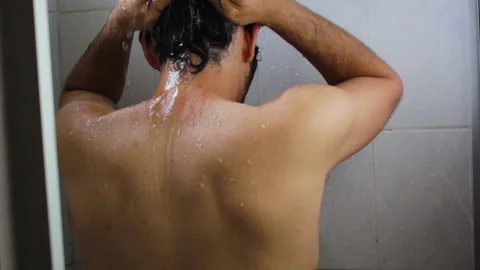 Bearded Hispanic young man taking a relaxing bath in the bathroom shower Video stock 132537445