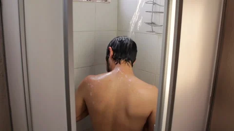 Bearded Hispanic young man taking a relaxing bath in the bathroom shower Video stock 132545818