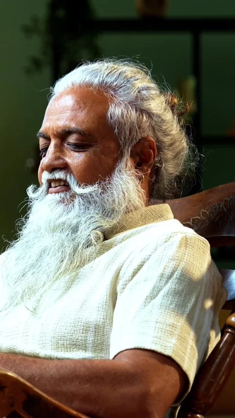 Bearded Indian stylish man messaging on mobile phone while sitting indoors Stock Footage 342757037