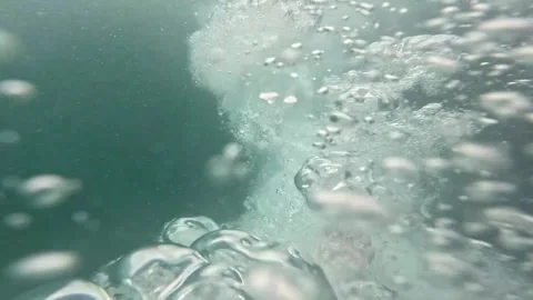A bearded Indonesian man performs a stunt jumping from a boat at Labuan Bajo Stock-Footage 279892690