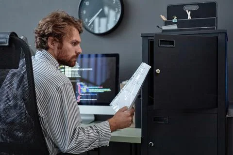 Bearded IT Programmer Reading Document Stock Photos