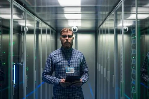 Bearded IT specialist setting servers in data center Stock Photos