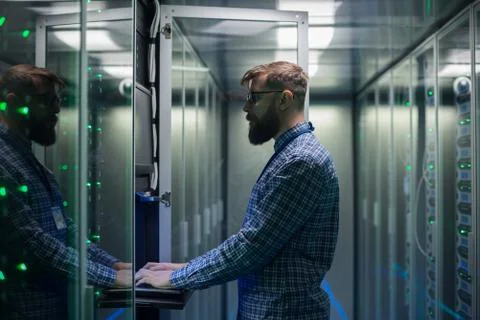 Bearded IT specialist setting servers in data center Stock Photos