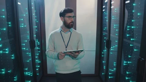 Bearded IT specialist using digital laptop walking in computer security Stock Footage 119231771