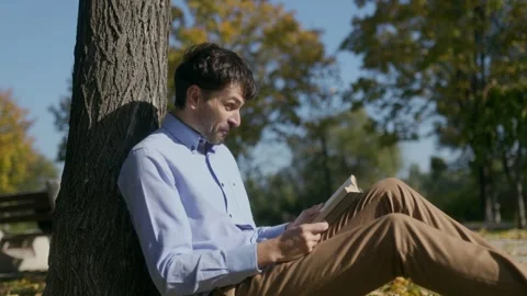 Bearded Learner Stunned by What He Reading, Enjoying Nature Beauty Stock Footage 300249299