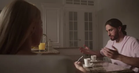 Bearded male model explaining work plan to female artist Stock Footage 251522703