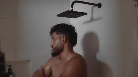 Bearded male taking a refreshing shower Stock Footage 336974463