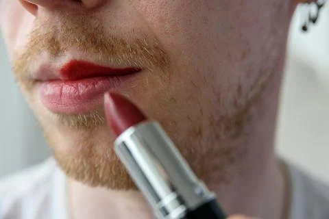 Bearded man applying lipstick Stock Photos