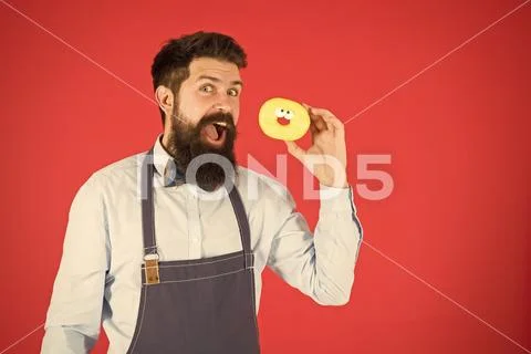 Bearded man in apron. Diet and healthy food. Donut diet. Calorie. Feel hunger Stock Photos