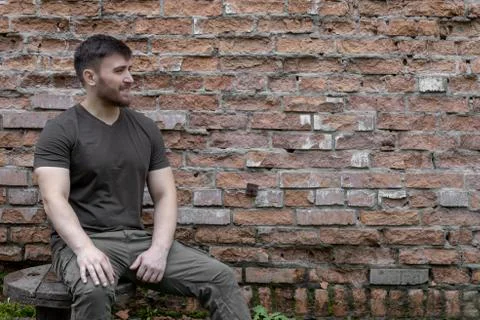 Bearded man on a background of a brick wall. Stock Photos