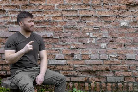 Bearded man on a background of a brick wall. Stock Photos