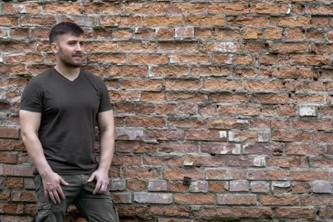 Bearded man on a background of a brick wall. Stock Photos