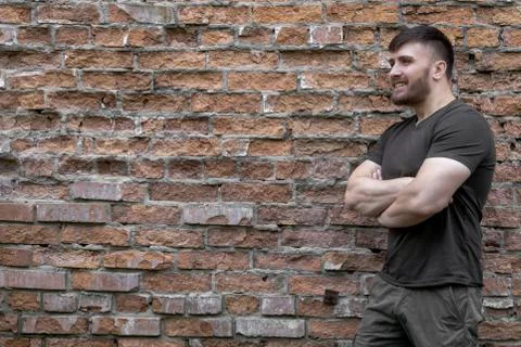 Bearded man on a background of a brick wall. Stock Photos