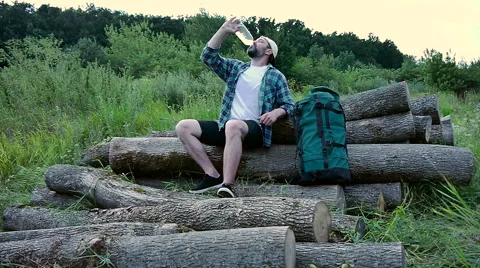 Bearded man with backpack drinking water Stock Footage 65482872