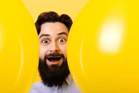 Bearded man with balloons Stock Photos